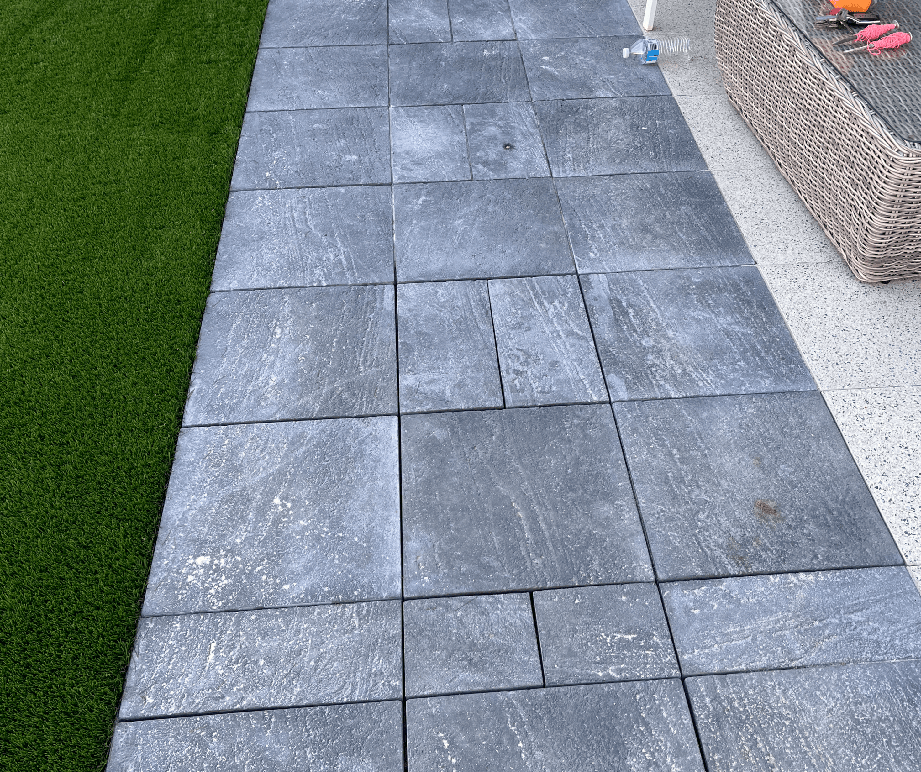 Large charcoal slab path laid beside artificial grass