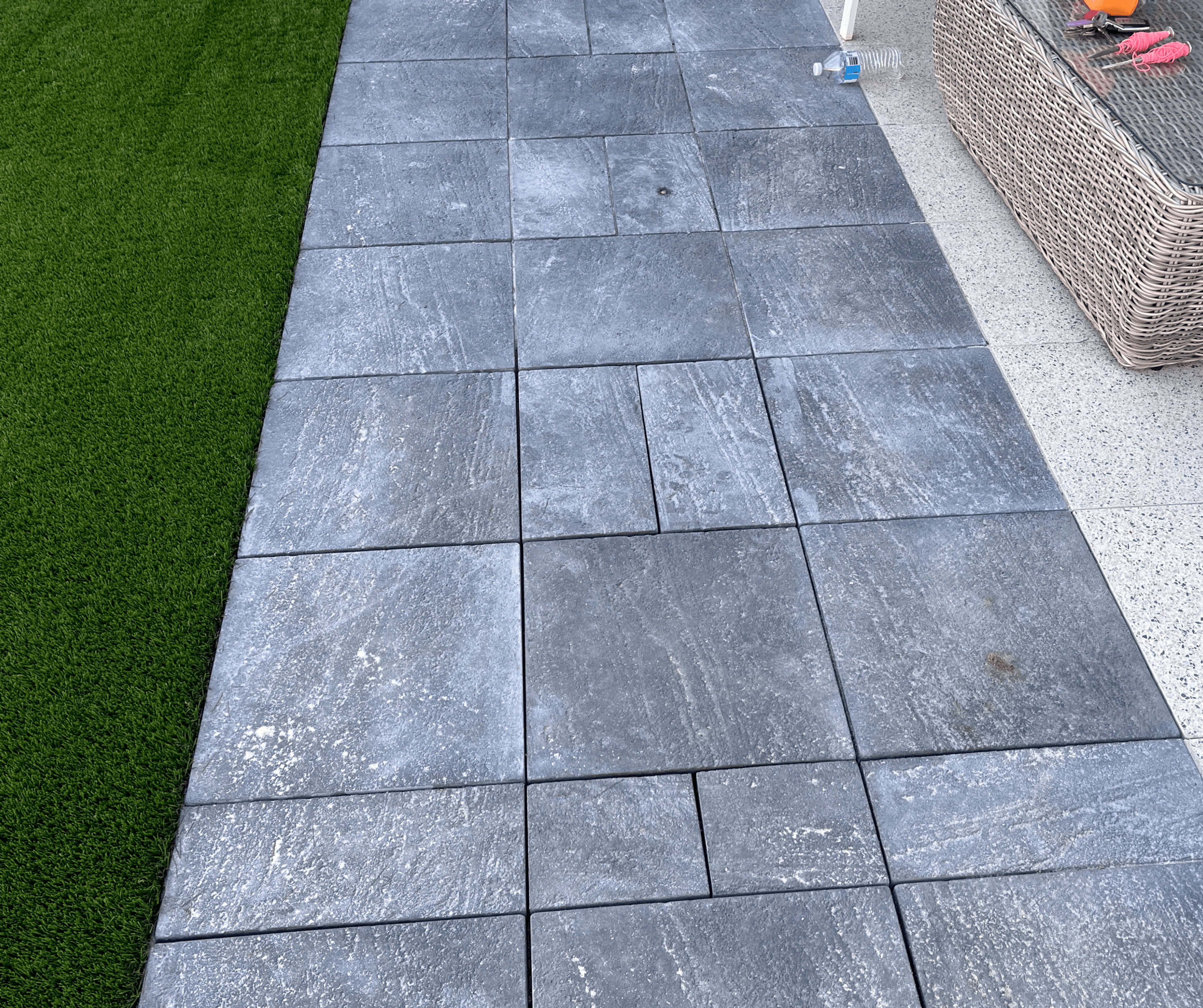Large charcoal slab path laid beside artificial grass